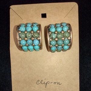 Pair of clip-on earrings. Shades of turquoise stones in copper setting.